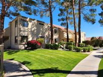 Inviting condo with lush landscaping, mature trees, and well-maintained lawn and walkways at 3750 Desert Marina Dr # 37, Laughlin, NV 89029