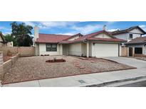 Charming single-story home with a red-tile roof, two-car garage, and low maintenance desert landscaping at 4308 Apex Dr, Las Vegas, NV 89147