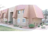 An exterior view showcasing a two-story condo with a tiled roof and stone facade at 4965 Indian River Dr # 101, Las Vegas, NV 89103