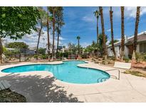 Community pool with mature landscaping, ample deck area, and comfortable seating at 516 Delfern Ln, Las Vegas, NV 89169