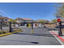 Gated community entrance with well-maintained landscaping, and visible neighborhood homes at 5642 Breckenridge St, North Las Vegas, NV 89081