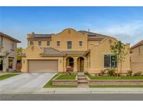 Charming two-story home featuring a tile roof, well-manicured landscaping, and a two car garage at 5642 Breckenridge St, North Las Vegas, NV 89081