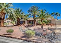 Beautiful single-story home with lush desert landscaping and towering palm trees at 6117 Foxcroft Ave, Las Vegas, NV 89108