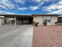 Single-story home featuring a covered carport, tidy landscaping, and a welcoming facade at 6241 Factor Ave, Las Vegas, NV 89107