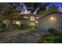 Charming two-story home with a tile roof, well-maintained landscaping, and attached two-car garage at 6925 Emerald Springs Ln, Las Vegas, NV 89113