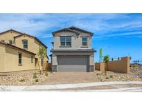 Charming two-story home with a well-manicured front yard and a paved driveway at 77 Tardando Ave, Henderson, NV 89015