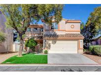 Charming two-story home with a well-maintained front yard and attached two-car garage at 7721 Sour Gum Ct, Las Vegas, NV 89131