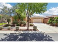 Charming single-story home with a well-manicured front yard and a two-car garage on a sunny day at 8316 Imperial Lakes St, Las Vegas, NV 89131