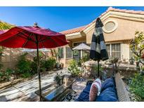 Charming courtyard features an outdoor sitting area, umbrellas, and lush landscaping at 8808 Litchfield Ave, Las Vegas, NV 89134