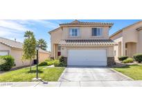 Charming two-story home features a manicured lawn, two car garage and desert landscaping at 9013 Meisenheimer Ave, Las Vegas, NV 89143