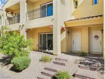 Charming townhome featuring a covered front porch and a well-maintained landscaped front yard at 985 Via Lombardi Ave, Henderson, NV 89011