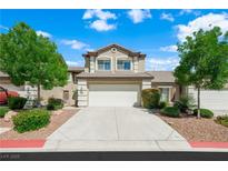 Charming two-story townhouse featuring a two-car garage, well-maintained landscaping and a concrete driveway at 10244 Amber Hue Ln, Las Vegas, NV 89144
