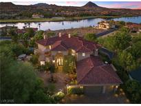 Stunning aerial view showcasing the home, lake views, landscaping, and surrounding neighborhood at 17 Grand Corniche Dr, Henderson, NV 89011