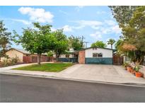 Charming single-story home featuring a well-manicured front lawn and mature trees at 1904 Fontenelle St, Las Vegas, NV 89102