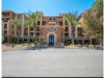 Stunning exterior view of a luxury building with manicured landscaping and towering palm trees at 20 Via Mantova # 306, Henderson, NV 89011