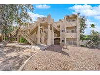 Multi-level condo building with beige exterior, open stairways, and landscaped grounds at 2007 Cutlass Dr # 0, Henderson, NV 89014