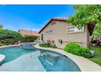 Inviting pool and spa with blue tile accents and lush landscaping at 224 Silver Castle St, Las Vegas, NV 89144