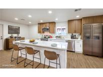 Modern kitchen boasts stainless steel appliances, an island with seating, and a bright, airy atmosphere at 2536 Herrod Dr, North Las Vegas, NV 89030