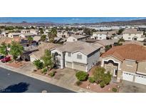 Two-story home featuring a two-car garage, desert landscaping and tile roof at 272 Violet Note St, Henderson, NV 89074