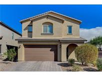Two-story home featuring a two-car garage, arched entry and desert landscaping under a bright blue sky at 2796 Sipe Springs St, Las Vegas, NV 89142