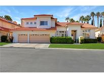 Inviting two-story home boasts a three-car garage, lush landscaping, and a red tile roof at 2909 Sterling Cove Dr, Las Vegas, NV 89128