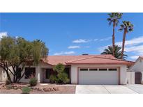 Charming single-story home features a tile roof, mature landscaping, and an attached two-car garage at 3024 Nutwood St, Las Vegas, NV 89108