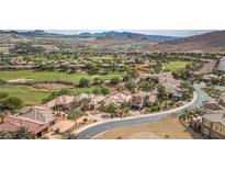 Stunning aerial view of a luxury home in a golf course community with mountain views at 32 Cerchio Basso, Henderson, NV 89011