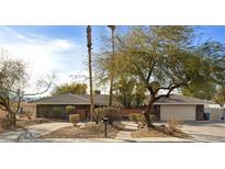 Charming single-story home with desert landscaping, mature trees, and a spacious driveway at 3845 S Torrey Pines Dr, Las Vegas, NV 89103