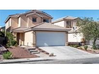 Two-story home featuring an attached two-car garage with a driveway and landscaped front yard at 4846 Lone Grove Dr, Las Vegas, NV 89139