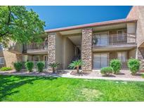 Condominium exterior featuring well-maintained lawn, stone accents and multiple balconies at 4980 Indian River Dr # 447, Las Vegas, NV 89103