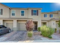 Beautiful townhome featuring a well-kept lawn and a brick driveway, offering both curb appeal and convenient parking at 5269 Silver Branch Ave, Las Vegas, NV 89118