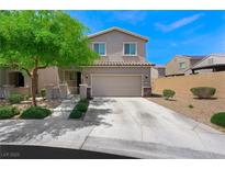 Charming two-story home with desert landscaping, green tree and covered front porch at 5631 Hill Cliff Ct, North Las Vegas, NV 89031
