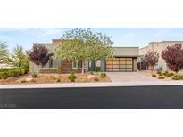Beautiful single-story home with desert landscaping and an elegant garage door at 6194 Stone Rise St, Las Vegas, NV 89135