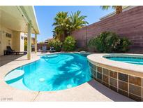 Inviting pool and spa area with mature landscaping and lounge seating at 6251 Tuckaway Cove Ave, Las Vegas, NV 89139