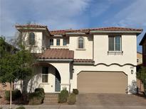 Charming two-story home with a two-car garage, a red tile roof, and desert landscaping at 632 Cadence Vista Dr, Henderson, NV 89011