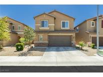 Charming two-story home featuring desert landscaping, a two-car garage, and a classic stucco facade at 6409 Dundock Ave, Las Vegas, NV 89122