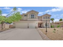 Inviting two-story home with a three-car garage, balcony and desert landscaping at 7211 Heggie Ave, Las Vegas, NV 89131