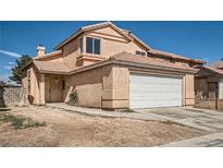 Two-story home featuring a two-car garage, desert landscaping, and a tile roof at 725 Weatherstone Dr, Las Vegas, NV 89110
