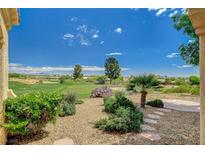 Expansive backyard view overlooking the golf course with lush landscaping and desert plants at 10562 Cerotto Ln, Las Vegas, NV 89135