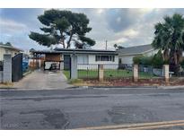 Charming single-story home featuring a well-maintained lawn and a classic fence for a welcoming curb appeal at 1917 Cedar Ave, Las Vegas, NV 89101