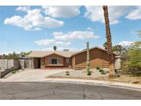 Ranch home featuring a desert landscape, brown exterior, and a long driveway at 204 Breeze St, Las Vegas, NV 89145