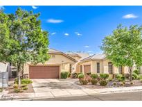 Charming single-story home with desert landscaping, mature trees, and a two-car garage at 2561 Pyramid Pines Dr, Henderson, NV 89052