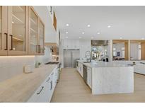Bright kitchen features light wood floors, granite countertops, stainless steel appliances, and ample counter and cabinet space at 2621 Spalding Dr, Las Vegas, NV 89134