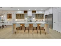 Modern kitchen features a large island with seating, custom cabinets, and stainless steel appliances at 2621 Spalding Dr, Las Vegas, NV 89134