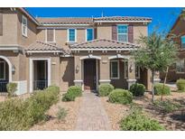Inviting townhouse with brick walkway, desert landscaping, and a well-maintained facade at 3270 Trabia Ave, Henderson, NV 89044