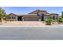 Inviting one-story home featuring a three-car garage and a beautifully paved driveway at 3906 Jacob Lake Cir, Las Vegas, NV 89118