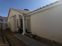 Modest single-story home with a tiled roof and simple landscaping at 4607 Chestnut Blaze Dr, North Las Vegas, NV 89032