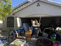 Exterior shot of home featuring a garage filled with furniture and other household items at 4607 Chestnut Blaze Dr, North Las Vegas, NV 89032