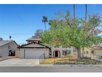 Charming two-story home with a front lawn, mature trees, and an attached two-car garage at 5019 Lancaster Dr, Las Vegas, NV 89120