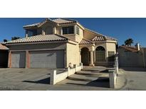 Charming two-story home featuring a well-maintained lawn, classic stucco finish, and a two-car garage at 529 Rancho Del Mar Way, North Las Vegas, NV 89031